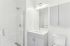 Sleek modern bathroom with elegant subway tile shower, stylish vanity, and ample storage.