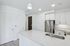 Sleek modern kitchen with quartz countertops, stainless steel appliances, and elegant pendant lighting.