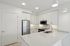 Modern kitchen with sleek white cabinetry, stainless steel appliances, and a spacious quartz countertop island, perfect for entertaining.