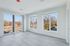 Bright and airy room with large windows offering scenic views of a lush landscape, perfect for sunlit living space.
