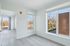 Bright and airy room with large windows offering a scenic view, featuring modern light hardwood floors and sleek minimalist design.