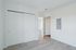 Modern white room with sleek sliding closet doors and light wood flooring, ideal for a fresh start.
