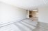 Bright, open-concept living space with fresh carpet and a cozy kitchen, perfect for modern living.