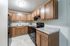 Contemporary kitchen with sleek wooden cabinets, elegant countertops, and modern appliances, offering a warm and inviting culinary space.