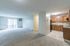 Bright and spacious apartment with an open living area, modern kitchen, and large windows for natural light.