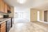 Inviting open-concept apartment featuring a modern kitchen, spacious living area, and large windows for natural light.