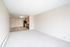 Bright and spacious open-plan living area with modern kitchen, featuring sleek appliances and ample natural light.