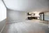 Bright open-concept living space featuring modern kitchen with stainless steel appliances and sleek cabinetry.
