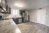 Bright and modern kitchen featuring sleek stainless steel appliances, elegant granite countertops, and ample cabinetry.