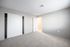 Bright and airy bedroom with plush carpet, ample closet space, and fresh, modern decor.