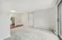 Bright and inviting apartment with plush carpeting, open-layout transitioning to modern kitchen with stainless steel appliances.