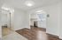 Bright and inviting apartment space featuring a modern kitchen with stainless steel appliances, elegant hardwood flooring, and plush carpeted areas.