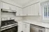 Modern kitchen with sleek white cabinetry, stainless steel appliances, and plenty of natural light.