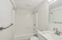 Bright and modern bathroom with elegant fixtures and a pristine white bathtub, offering a serene space for relaxation.