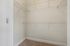 Princeton Westford Apartments | Empty walk-in closet with beige carpet, white walls, and multiple white wire shelves makes an ideal linen closet in this apartment in Westford, MA. | Apartments with Balcony in Westford