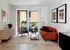 Your light-filled living room connects seamlessly to the kitchen and balcony, offering the perfect flow for daily relaxation. | The Charley | Apartment in Allston, MA
