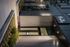 Modern building entrance with a sign reading The Charley above the door. Glass doors, address number 46, outdoor lighting, and neatly landscaped plants line the sidewalk at The Charley Apartments in Allston MA. It appears to be evening. | The Charley | Apartment in Allston, MA