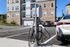 EV Charging Station with cables installed in the parking lot of The James Apartments in Haverhill, MA, with several cars parked nearby on a sunny day. The James | Apartment in Haverhill, MA