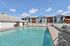 Sparkling outdoor swimming pool surrounded by a spacious sundeck and lounge chairs at our pet-friendly apartments in Worcester, MA. | Princeton Place Apartments | Pet Friendly Apartments in Worcester