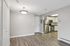 Princeton Properties | Experience modern living at Brookstone Manor Apartments in Milford, New Hampshire—enjoy light gray walls, wood-style flooring, an overhead light fixture, and an open kitchen with stainless steel appliances and white cabinets. | Apartments with Washer & Dryer in Milford