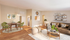 Elegant and cozy living room with warm wooden flooring, a stylish brown sofa adorned with chic cushions, and a contemporary dining area featuring vibrant green chairs and a modern table.| The Royal Crest | Apartment in North Andover, MA