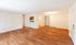 Bright and spacious living area with elegant wooden flooring and open layout, perfect for a modern lifestyle.| The Royal Crest | Apartment in North Andover, MA