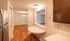 Inviting apartment interior with modern stainless steel appliances, elegant wood flooring, and a stylish open shelf design.Your spacious kitchen offers generous square footage with room for multiple people and all your cooking essentials.  | The Royal Crest | Apartment in,North Andover MA