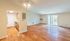 Bright and spacious open-concept living area featuring elegant wood flooring and sliding glass doors leading to a sunlit balcony, seamlessly connected to a charming kitchen.Your spacious kitchen offers generous square footage with room for multiple people and all your cooking essentials.  | The Royal Crest | Apartment in,North Andover MA