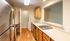 Contemporary kitchen with stainless steel appliances, sleek countertops, and inviting wood flooring.Your spacious kitchen offers generous square footage with room for multiple people and all your cooking essentials.  | The Royal Crest | Apartment in,North Andover MA