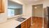 Inviting kitchen space with stainless steel appliances, elegant wooden cabinets, and a modern open-pass design inviting natural light.Your spacious kitchen offers generous square footage with room for multiple people and all your cooking essentials.  | The Royal Crest | Apartment in,North Andover MA