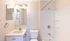 Bright and inviting bathroom featuring a sleek vanity, a modern bathtub with subtle shelving, and soft ambient lighting.Your spacious kitchen offers generous square footage with room for multiple people and all your cooking essentials.  | The Royal Crest | Apartment in,North Andover MA