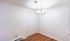 Bright dining area with elegant chandelier and stylish double closet doors, featuring modern wood flooring and white walls.Your spacious kitchen offers generous square footage with room for multiple people and all your cooking essentials.  | The Royal Crest | Apartment in,North Andover MA
