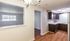 Bright apartment featuring a cozy kitchen with dark wood cabinets, adjacent to a window-lit room with a charming view.Your spacious kitchen offers generous square footage with room for multiple people and all your cooking essentials.  | The Royal Crest | Apartment in,North Andover MA