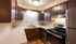 Charming kitchen with rustic brown cabinetry, modern appliances, and ample counter space.Your spacious kitchen offers generous square footage with room for multiple people and all your cooking essentials.  | The Royal Crest | Apartment in,North Andover MA