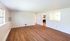 Bright and spacious living area with elegant wood flooring, ample natural light, and a peek into the modern kitchen.Your spacious kitchen offers generous square footage with room for multiple people and all your cooking essentials.  | The Royal Crest | Apartment in,North Andover MA