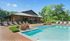 The seasonal swimming pool is surrounded by lush landscaping and comfortable cabanas, delivering a vacation feel right at home. | The Royal Crest | Apartment in North Andover, MA