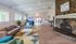 Spacious and inviting communal living area with modern furnishings, cozy fireplace, and entertainment facilities, perfect for relaxation and social gatherings.| The Royal Crest | Apartment in North Andover, MA