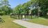 Charming outdoor dog park with secure fencing, lush greenery, and serene pathways, offering a perfect pet-friendly environment.| The Royal Crest | Apartment in North Andover, MA