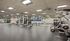 A modern gym facility offers high-end weight stations and expansive windows, providing a bright space to stay active. | The Royal Crest | Apartment in North Andover, MA