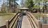 Charming walkway over a serene pond leading to a cozy gazebo, nestled amidst lush trees and natural beauty.| The Royal Crest | Apartment in North Andover, MA