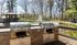 Inviting outdoor space with dual stainless steel grills overlooking a peaceful pond and gazebo, perfect for relaxed gatherings.| The Royal Crest | Apartment in North Andover, MA