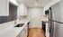 Modern kitchen with sleek stainless steel appliances, elegant white cabinetry, and polished wood floors.Your spacious kitchen offers generous square footage with room for multiple people and all your cooking essentials.  | The Royal Crest | Apartment in,North Andover MA