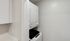 Compact laundry area with stacked washer and dryer, offering functional and space-saving convenience for modern living.Your spacious kitchen offers generous square footage with room for multiple people and all your cooking essentials.  | The Royal Crest | Apartment in,North Andover MA
