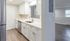 Modern kitchen with sleek stainless steel appliances, elegant white cabinetry, and a spacious countertop, leading to a bright, open living area.Your spacious kitchen offers generous square footage with room for multiple people and all your cooking essentials.  | The Royal Crest | Apartment in,North Andover MA
