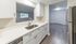 Modern kitchen with sleek countertops, stainless steel appliances, and an open view to a spacious living area.Your spacious kitchen offers generous square footage with room for multiple people and all your cooking essentials.  | The Royal Crest | Apartment in,North Andover MA