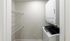 Modern laundry room featuring a convenient stacked washer and dryer set with ample shelving for storage.Your spacious kitchen offers generous square footage with room for multiple people and all your cooking essentials.  | The Royal Crest | Apartment in,North Andover MA