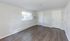 Bright, spacious room with elegant wood flooring, large window with natural light, and sleek white walls, offering a versatile living space.Your spacious kitchen offers generous square footage with room for multiple people and all your cooking essentials.  | The Royal Crest | Apartment in,North Andover MA