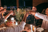 Charming dinner party scene with friends toasting around a candlelit table adorned with elegant floral arrangements and delectable appetizers  | Princeton on Beacon Street | Princeton on Beacon Street Apartments