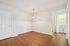 Bright, airy room with wood flooring, sleek pendant lighting, and convenient washer-dryer setup in laundry area.| Village Green | Apartment in Tewksbury, MA