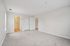 Spacious and bright bedroom with plush carpeting, featuring a modern ensuite bathroom and double door closets.| Village Green | Apartment in Tewksbury, MA